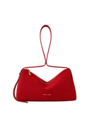 A red suede shoulder bag with a single loop handle and gold-tone hardware, shown against a plain light gray background.